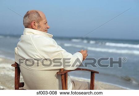 Senior man looking at waves View Large Photo Image Stock Photo - Senior man looking at waves. Fotosearch