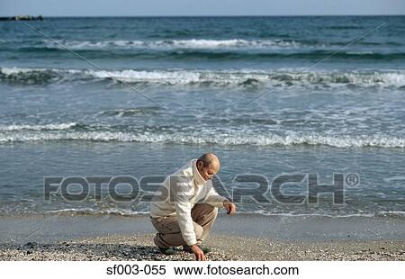 Senior man picking up shingle View Large Photo Image Stock Photography - Senior man picking up shingle. Fotosearch