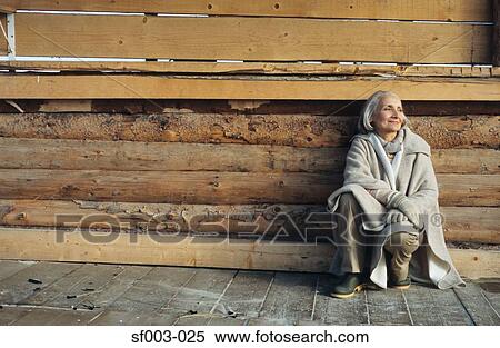 Stock Photography - Senior woman crouching. Fotosearch