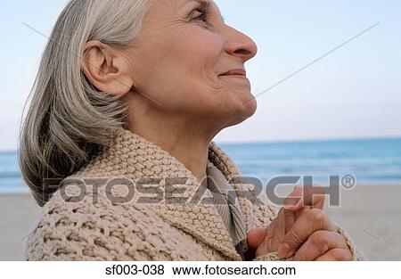Senior woman looking spiritual View Large Photo Image Stock Photo - Senior woman looking spiritual. Fotosearch