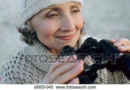 Senior woman using binoculars View Large Photo Image Stock Photography - Senior woman using binoculars. Fotosearch
