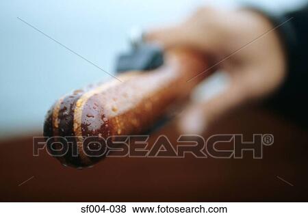 Close-up of hand holding wooden handle View Large Photo Image Stock Photo - Close-up of hand holding wooden handle. Fotosearch