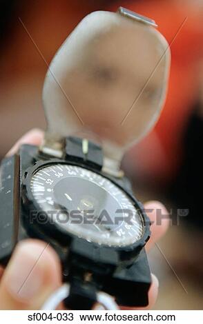 Close-up of person holding compass View Large Photo Image Stock Image - Close-up of person holding compass. Fotosearch