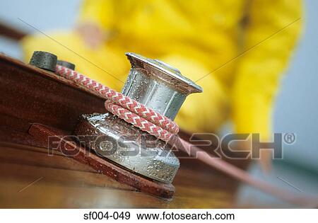 Close-up of rope around capstan with person in yellow waterproofs View Large Photo Image Stock Photo - Close-up of rope around capstan with person in yellow waterproofs. Fotosearch