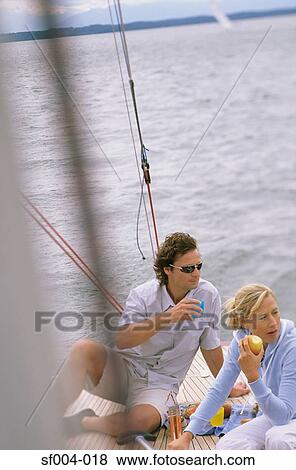Couple on boat eating lunch View Large Photo Image Stock Photo - Couple on boat eating lunch. Fotosearch