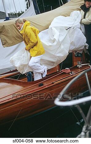 Couple putting sail away View Large Photo Image Stock Photo - Couple putting sail away. Fotosearch