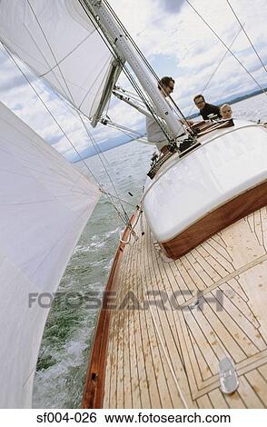 Stock Photograph - Group of friends on a boat. Fotosearch