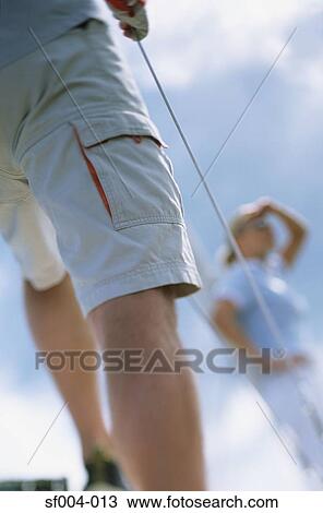 Legs of man on boat with woman in background View Large Photo Image Stock Image - Legs of man on boat with woman in background. Fotosearch