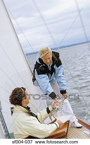 Man handing anchor to woman View Large Photo Image Stock Photo - Man handing anchor to woman . Fotosearch