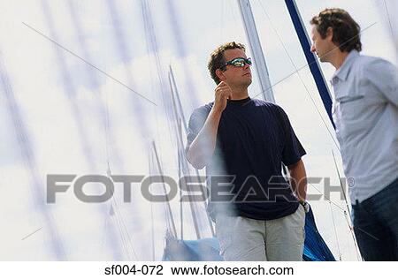 Men talking on harbour View Large Photo Image Stock Image - Men talking on harbour. Fotosearch