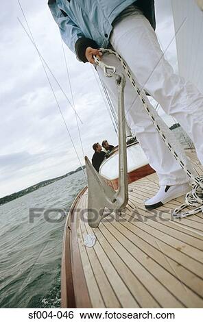 Person on deck of boat holding anchor View Large Photo Image Stock Photograph - Person on deck of boat holding anchor. Fotosearch