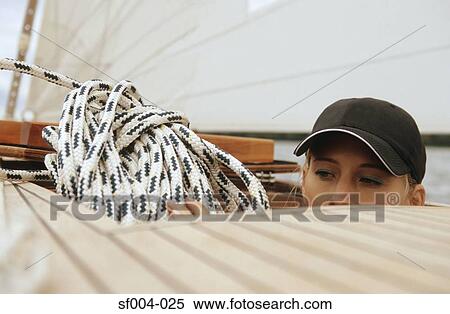 Woman holding rope below deck of boat View Large Photo Image Stock Photography - Woman holding rope below deck of boat. Fotosearch