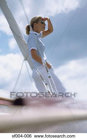Stock Photograph - Woman on boat looking out to sea. Fotosearch