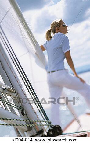 Woman standing on boat looking out to sea View Large Photo Image Picture - Woman standing on boat looking out to sea. Fotosearch