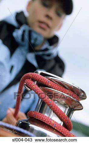 Woman winding rope around crank View Large Photo Image Stock Image - Woman winding rope around crank. Fotosearch