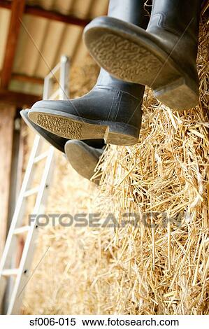 Stock Photography - People in rubber boots sitting on a hale bay. Fotosearch