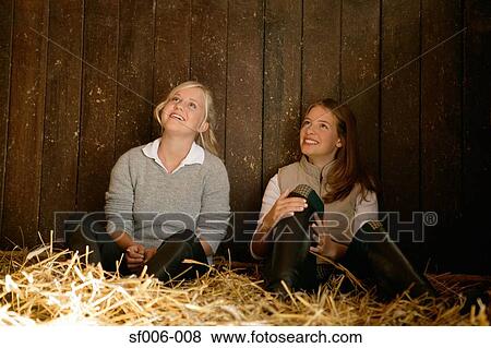 Two young women in a stable View Large Photo Image Stock Photo - Two young women in a stable. Fotosearch