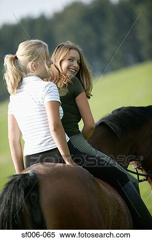 Two young women on a horse View Large Photo Image Stock Photography - Two young women on a horse. Fotosearch