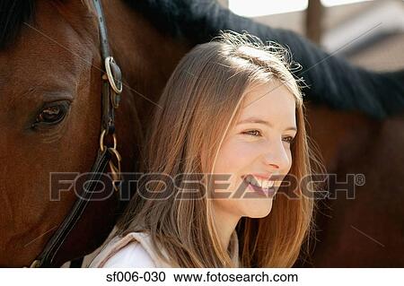 Young woman and her horse View Large Photo Image Stock Image - Young woman and her horse. Fotosearch