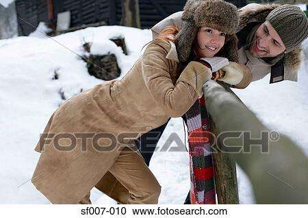 Stock Image - Couple outside in the snow. Fotosearch