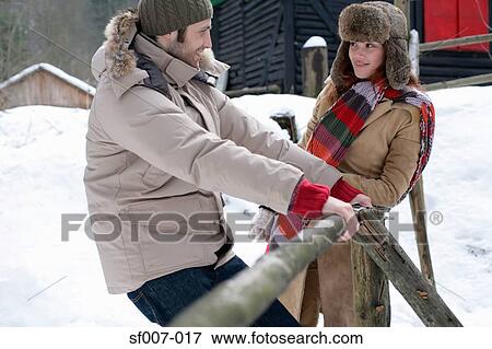 Couple outside in the snow View Large Photo Image Stock Photo - Couple outside in the snow. Fotosearch