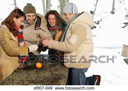 Friends raising a toast outside View Large Photo Image Stock Photo - Friends raising a toast outside. Fotosearch