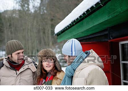 Friends talking outside a hut View Large Photo Image Stock Image - Friends talking outside a hut. Fotosearch
