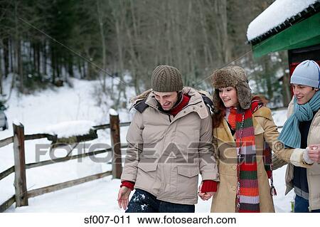 Friends walking in the snow View Large Photo Image Stock Image - Friends walking in the snow. Fotosearch