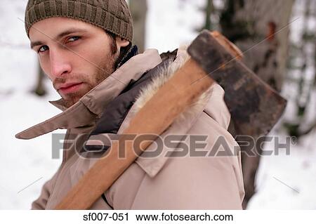 Stock Image - Man carrying an axe. Fotosearch