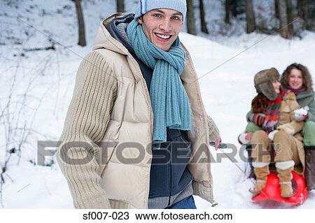 Man pulling women on a sled View Large Photo Image Stock Image - Man pulling women on a sled. Fotosearch