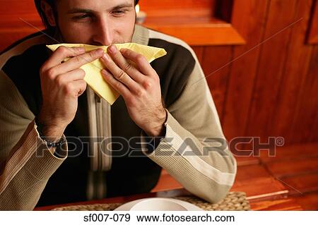 Man wiping his mouth with napkin View Large Photo Image Stock Photo - Man wiping his mouth with napkin. Fotosearch