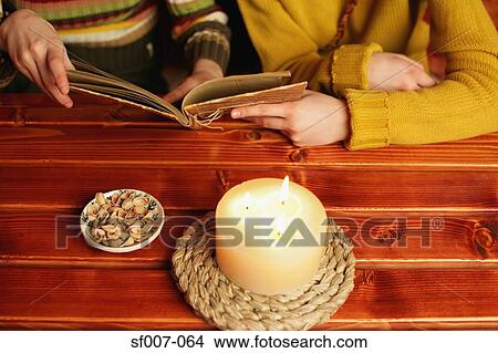 Two women sharing a book View Large Photo Image Picture - Two women sharing a book. Fotosearch