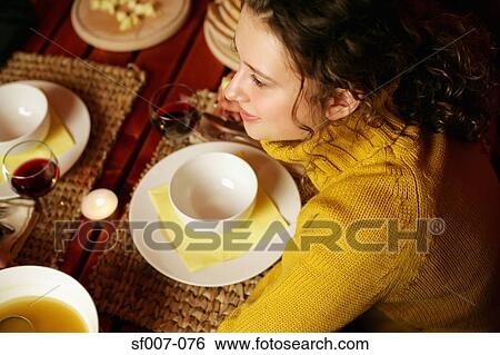 Woman at the dinner table View Large Photo Image Stock Photograph - Woman at the dinner table. Fotosearch