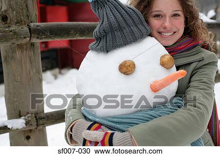 Woman hugging a snowman View Large Photo Image Stock Image - Woman hugging a snowman. Fotosearch