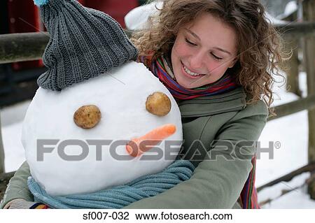 Woman hugging a snowman View Large Photo Image Stock Image - Woman hugging a snowman. Fotosearch