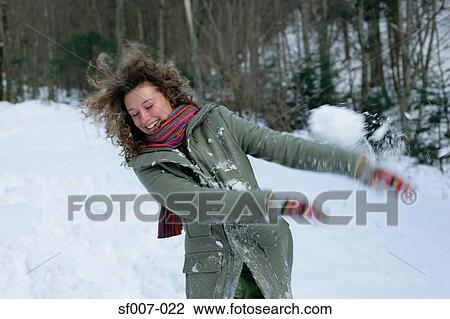 Woman in snowball fight View Large Photo Image Stock Image - Woman in snowball fight. Fotosearch