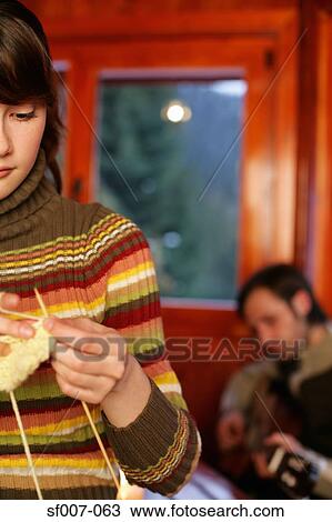 Woman knitting as man plays guitar View Large Photo Image Stock Image - Woman knitting as man plays guitar. Fotosearch