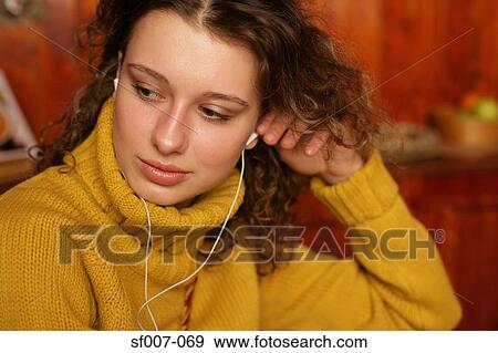 Woman listening to personal stereo View Large Photo Image Stock Photo - Woman listening to personal stereo. Fotosearch