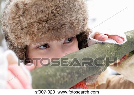 Woman peeking over a fence View Large Photo Image Stock Image - Woman peeking over a fence. Fotosearch