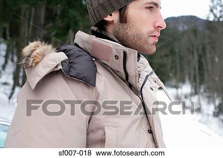 Young man outside in the snow View Large Photo Image Stock Photo - Young man outside in the snow. Fotosearch