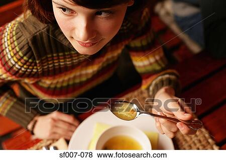 Young woman eating soup View Large Photo Image Stock Photo - Young woman eating soup. Fotosearch