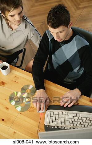 Colleagues at their desk View Large Photo Image Stock Image - Colleagues at their desk. Fotosearch