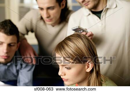 Stock Image - Colleagues working together. Fotosearch