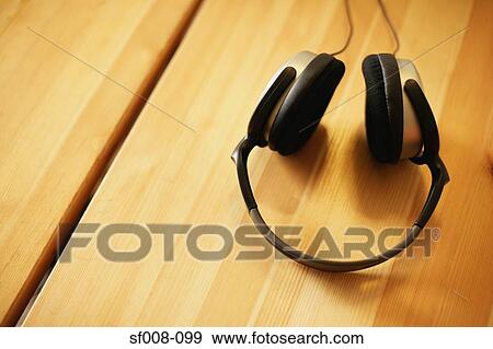 Stock Photo - Headphones on a table. Fotosearch