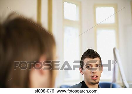 Stock Photograph - Male colleagues having a discussion. Fotosearch