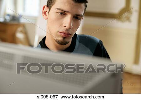 Man at his computer View Large Photo Image Stock Photo - Man at his computer. Fotosearch