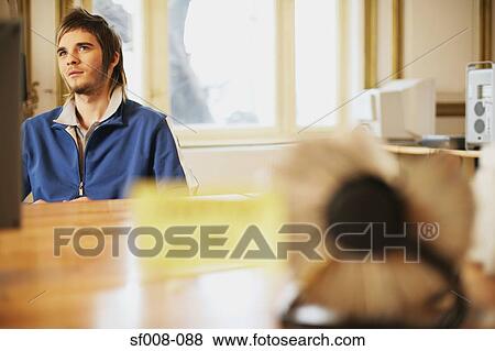 Man daydreaming at his desk View Large Photo Image Stock Photo - Man daydreaming at his desk. Fotosearch