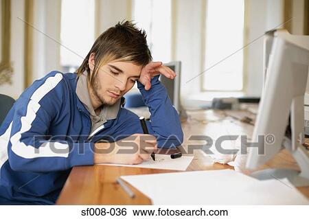 Man drawing at his desk View Large Photo Image Stock Photograph - Man drawing at his desk. Fotosearch