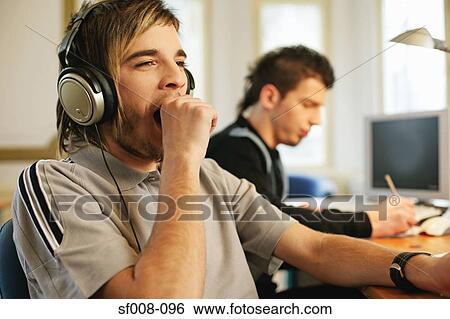 Man in headphones yawning View Large Photo Image Stock Photograph - Man in headphones yawning. Fotosearch
