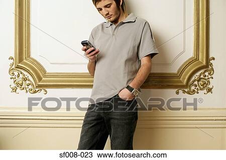 Man reading a text message View Large Photo Image Stock Image - Man reading a text message. Fotosearch